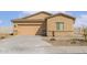 Tan single-story home featuring a two-car garage and neutral desert landscaping at 680 W Crowned Dove Trl, Casa Grande, AZ 85122