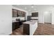 Modern kitchen featuring granite countertops, stainless appliances, and dark wood cabinets at 680 W Crowned Dove Trl, Casa Grande, AZ 85122