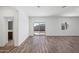 Bright living room with wood flooring and a sliding glass door to the backyard at 680 W Crowned Dove Trl, Casa Grande, AZ 85122