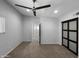 Light-filled bedroom boasts carpet, a ceiling fan, neutral paint, and sliding door closet at 4925 N 73Rd St # 4, Scottsdale, AZ 85251