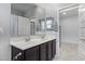 Bright bathroom featuring a double sink vanity with framed mirror and an adjoining toilet room at 37127 N Big Bend Rd, San Tan Valley, AZ 85140