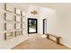 Welcoming foyer with light hardwood flooring, natural light, modern art, and minimalistic bench at 4350 N Jokake Dr, Scottsdale, AZ 85251