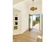 Inviting foyer featuring bright white walls, light wood floors, and unique decor at 4350 N Jokake Dr, Scottsdale, AZ 85251