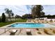 Relaxing backyard oasis featuring a sparkling swimming pool, lounge chairs, and lush landscaping at 4350 N Jokake Dr, Scottsdale, AZ 85251