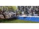 Outdoor tennis court featuring lighting, a gazebo, and mature trees at 4350 N Jokake Dr, Scottsdale, AZ 85251