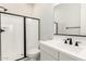 Updated bathroom featuring black framed shower doors and a single sink at 20262 W Hollyhock St, Buckeye, AZ 85396