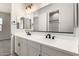 This bathroom has a double sink vanity, a large mirror, and sleek fixtures at 20262 W Hollyhock St, Buckeye, AZ 85396