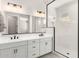 Beautiful bathroom featuring dual sinks, white cabinets, and glass shower at 20262 W Hollyhock St, Buckeye, AZ 85396