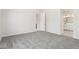 Bedroom boasts plush carpet, closet and en-suite bathroom entrance at 20262 W Hollyhock St, Buckeye, AZ 85396