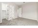 Bedroom with doors to closet and other rooms with light-colored walls and neutral color carpet at 20262 W Hollyhock St, Buckeye, AZ 85396