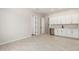 Bonus room with tile floors, white cabinets, sink and countertop with doors leading to other rooms at 20262 W Hollyhock St, Buckeye, AZ 85396