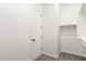 A neutral-toned walk-in closet with ample shelving and door at 20262 W Hollyhock St, Buckeye, AZ 85396