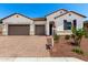 Charming single-story home featuring a brick driveway, three-car garage, and well-maintained landscaping at 20262 W Hollyhock St, Buckeye, AZ 85396