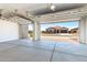 Spacious garage with concrete floors and open view to the front of the home at 20262 W Hollyhock St, Buckeye, AZ 85396