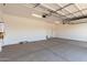 Spacious garage with concrete floors, ample lighting, and a door leading to the home's interior at 20262 W Hollyhock St, Buckeye, AZ 85396