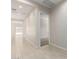 Neutral hallway with tile floors leading to rooms and a view to the outdoors through sliding glass doors at 20262 W Hollyhock St, Buckeye, AZ 85396