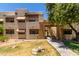 Spanish style condo building with a grassy area and walkway at 3434 E Baseline Rd # 259, Phoenix, AZ 85042