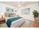 Cozy bedroom with a plush rug, side tables with lamps, and natural light from the window at 9710 W Campana Dr, Sun City, AZ 85351