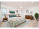 Serene main bedroom featuring ample natural light, soft colors, and comfortable furnishings at 9710 W Campana Dr, Sun City, AZ 85351