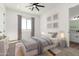 Cozy bedroom with a queen bed, neutral colors, decorative pillows, and a large window at 31730 N 169Th Ave, Surprise, AZ 85387