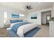 Bright primary bedroom suite, featuring a ceiling fan, plush carpet, and plenty of natural light at 31730 N 169Th Ave, Surprise, AZ 85387