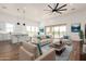Open concept living room features modern furniture, a ceiling fan, and seamless indoor-outdoor living at 31730 N 169Th Ave, Surprise, AZ 85387