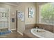 Spa-like bathroom with soaking tub, double vanity, and walk-in shower at 7054 E Ingram St, Mesa, AZ 85207