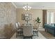 Formal dining room with stone accent wall and chandelier at 7054 E Ingram St, Mesa, AZ 85207