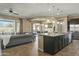 Island kitchen with dark cabinets and granite countertops at 7054 E Ingram St, Mesa, AZ 85207