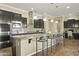 Eat-in kitchen island with granite countertops and dark cabinetry at 7054 E Ingram St, Mesa, AZ 85207