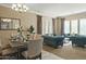 Bright living room with teal sofas and large windows at 7054 E Ingram St, Mesa, AZ 85207