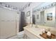 Bright bathroom featuring a step-in shower, vanity with storage, and ample lighting at 10802 W Cameo Dr, Sun City, AZ 85351