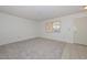 Bright bedroom featuring carpeted floors and a window providing plenty of natural light at 10802 W Cameo Dr, Sun City, AZ 85351