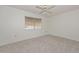 Cozy bedroom featuring neutral carpet, a ceiling fan, and a window with blinds at 10802 W Cameo Dr, Sun City, AZ 85351