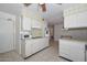 Bright kitchen with tile floors, white cabinets and stainless steel appliances at 10802 W Cameo Dr, Sun City, AZ 85351