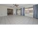 Sunny living room with tile floors, and seamless transition to other living spaces at 10802 W Cameo Dr, Sun City, AZ 85351