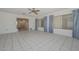 Inviting living area with bright light, neutral tile flooring, and an open layout at 10802 W Cameo Dr, Sun City, AZ 85351