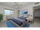 Serene main bedroom with a ceiling fan, carpet flooring, and a relaxing view overlooking the golf course at 10802 W Cameo Dr, Sun City, AZ 85351
