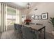 Elegant dining room with a wood table and gray chairs, bathed in natural light at 15273 S 31St St, Phoenix, AZ 85048