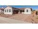 House exterior showcasing a brown garage door and landscaped yard at 16372 W Avenida Del Sol --, Surprise, AZ 85387