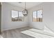 Dining area with large windows and a globe light fixture at 16355 W Avenida Del Sol --, Surprise, AZ 85387