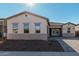 One-story home with light-colored exterior, a paved driveway, and landscaping at 16355 W Avenida Del Sol --, Surprise, AZ 85387