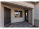 Covered front porch with double door entry and brick pavers at 16355 W Avenida Del Sol --, Surprise, AZ 85387