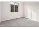 Well-lit bedroom featuring carpet and a window at 40519 W Wade Dr, Maricopa, AZ 85138