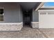 House exterior with dark gray siding and stone accents at 40519 W Wade Dr, Maricopa, AZ 85138