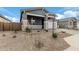 Single-story home with gray exterior, stone accents, and a two-car garage at 40519 W Wade Dr, Maricopa, AZ 85138