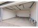 Attached garage with open door, showing ample space for parking at 40519 W Wade Dr, Maricopa, AZ 85138