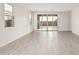 Living room with tile floors and sliding glass doors leading to patio at 40519 W Wade Dr, Maricopa, AZ 85138