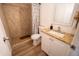 Bathroom with tiled walk-in shower, white vanity and granite countertop at 6337 N 49Th Ave, Glendale, AZ 85301