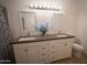 Bathroom featuring a granite countertop, double sinks, modern mirrors, and a toilet at 6337 N 49Th Ave, Glendale, AZ 85301
